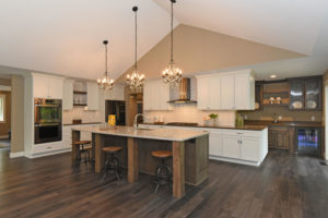 Custom home kitchen with wood and painted cabinets
